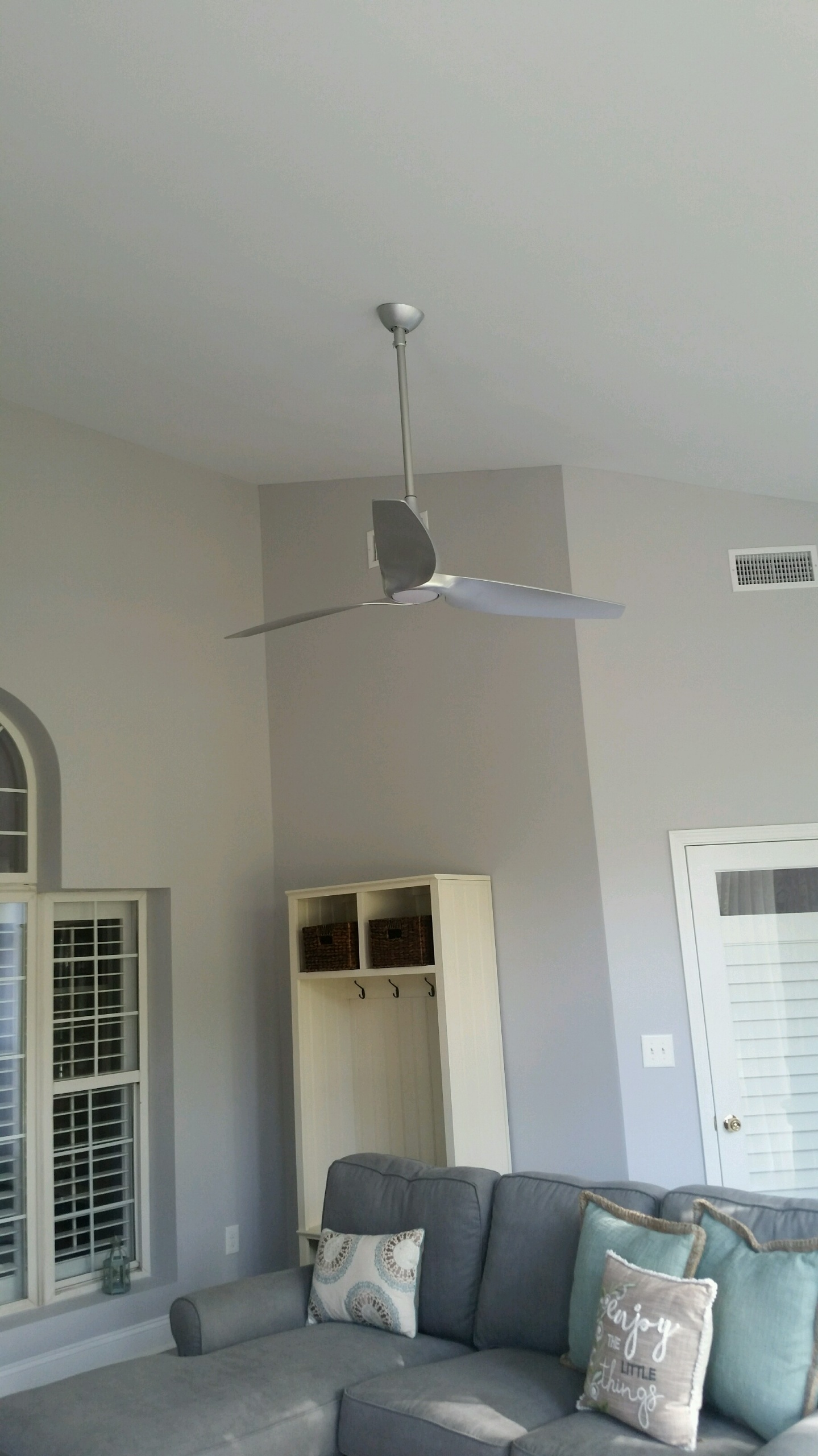 a ceiling fan above a sofa set